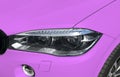 Headlight of a modern pink sport car. The front lights of the car. Modern Car exterior details. Royalty Free Stock Photo