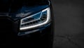 Headlight of Modern Prestigious Black Car Close Up. Royalty Free Stock Photo