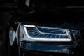 Headlight of Modern Prestigious Black Car Close Up. Royalty Free Stock Photo