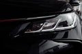 Headlight of modern prestigious black car close up. Close up photo of modern car, detail of headlight. Headlight car Projector LED Royalty Free Stock Photo