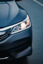 Headlight of modern prestigious black car close up. Close up photo of modern car, detail of headlight Royalty Free Stock Photo