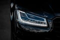 Headlight of Modern Prestigious Black Car Close Up. Royalty Free Stock Photo