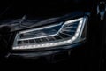 Headlight of Modern Prestigious Black Car Close Up. Royalty Free Stock Photo