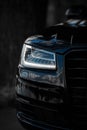 Headlight of Modern Prestigious Black Car Close Up. Royalty Free Stock Photo