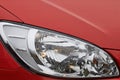 Headlight of modern red car, close-up view Royalty Free Stock Photo