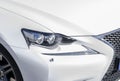 Headlight of a modern white sport car. The front lights of the car. Modern Car exterior details. Car detailing Royalty Free Stock Photo