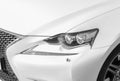 Headlight of a modern white sport car. The front lights of the car. Modern Car exterior details. Car detailing Royalty Free Stock Photo