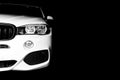 Headlight of a modern white sport car. The front lights of the car. Modern Car exterior details. Car detailing. Isolated on black Royalty Free Stock Photo