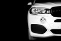 Headlight of a modern white sport car. The front lights of the car. Modern Car exterior details. Car detailing. Isolated on black Royalty Free Stock Photo