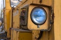 Headlight of an old abandoned broken road construction machine Royalty Free Stock Photo