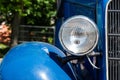 Headlight of an old beautiful blue car. Close-up. Copy space concept for banner repair, car sale