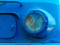 headlight of an old blue steam locomotive close up
