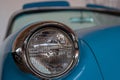 The headlight of an old, rarity, vintage blue car