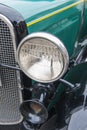 Headlight of an olive green classic car Royalty Free Stock Photo