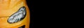 Headlight Opel Adam. The front of the yellow car. Banner with a yellow car on a black background Royalty Free Stock Photo