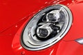 Headlight of Porsche red sport car series 911 carrera 4GTS