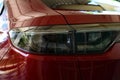 close up headlight of red car, transportation industry