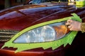 Headlight restore in the worker polishes optics of headlights of the car with the hand tool Royalty Free Stock Photo