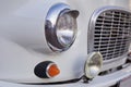 Headlight of a vintage retro car of gray color, close-up