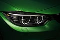 Headlights angel eyes green BMW M4 tuning in the dark Royalty Free Stock Photo