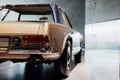 Headlights on the back and partical view. Photo of brown vintage polished and shiny car parked indoors