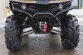 Headlights of black ATV quadbike isolated on city pavement, close up