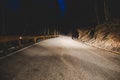 The headlights of a car on mountain road in the night Royalty Free Stock Photo