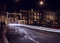 Headlights car passing down street in night Amsterdam.