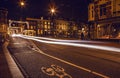 Headlights car passing down street in night Amsterdam.