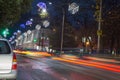 Headlights in dark street. Night traffic, cars on highway road on sunset evening night in busy city. Christmas in Town Royalty Free Stock Photo