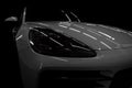 Headlights of new modern car on dark black background. Royalty Free Stock Photo