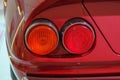 Headlights of the red sportscar close-up. Car details. Transportation. Car repair