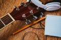 Headphone guitar notebook and pencil Royalty Free Stock Photo