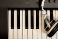 Headphone on key piano background. Royalty Free Stock Photo