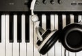 Headphone on key piano background. Royalty Free Stock Photo