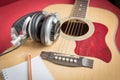 Headphone and Notebook and pencil on guitar Royalty Free Stock Photo