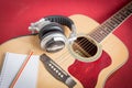 Headphone and Notebook and pencil on guitar Royalty Free Stock Photo