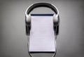 Headphones with blank notebook or notepad background with copy space for playlist or podcast Royalty Free Stock Photo