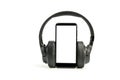 Headphones with Bluetooth technology on white background, with black phone paired for music lovers Royalty Free Stock Photo