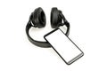 Headphones with Bluetooth technology on white background, with black phone paired for music lovers Royalty Free Stock Photo