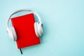 Headphones and books on blue background. Royalty Free Stock Photo