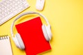 Headphones and books on blue background. Royalty Free Stock Photo