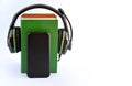 Headphones, books and smartphone on white background. Royalty Free Stock Photo