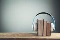 Headphones and books on wooden table. Audio book concept Royalty Free Stock Photo