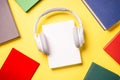 Headphones and books on yellow background. Royalty Free Stock Photo