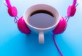 Headphones and coffee cup on blue background. Music concept. Top view with copy space Royalty Free Stock Photo