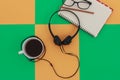 Headphones and Coffee cup a on difference colorful bright board. Music concept