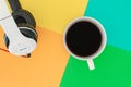 Headphones and Coffee cup a on difference colorful bright board. Music concept
