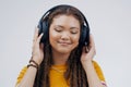 Headphones, dance or calm girl streaming music in studio for singing on grey background to relax. Gen z, podcast or Royalty Free Stock Photo
