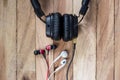 Headphones and earphones on grunge wooden background